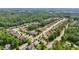 Scenic aerial view of a neighborhood with lush green trees and a glimpse of a lake in the background at 251 Parc Dr, Canton, GA 30114