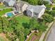 Overhead view of a home with a pool, patio, and spacious green lawn surrounded by trees at 251 Parc Dr, Canton, GA 30114