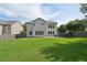Exterior view of the home from the backyard, showcasing a well-maintained lawn and a fenced perimeter at 251 Parc Dr, Canton, GA 30114