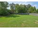 Expansive backyard with a lush green lawn and mature trees, offering plenty of space for recreation at 251 Parc Dr, Canton, GA 30114