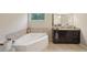 The bathroom features a large soaking tub and a dark vanity with granite countertops at 251 Parc Dr, Canton, GA 30114
