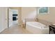 This bathroom features a soaking tub, and an adjacent door to the main bedroom at 251 Parc Dr, Canton, GA 30114