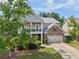 Charming two-story home with a welcoming front porch, landscaped yard, and attached two-car garage at 251 Parc Dr, Canton, GA 30114