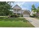 Charming two-story home featuring a double-decker porch, well-maintained lawn, and inviting curb appeal at 251 Parc Dr, Canton, GA 30114