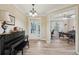 Bright foyer featuring hardwood floors, elegant lighting, and an open view into the adjacent living spaces at 251 Parc Dr, Canton, GA 30114