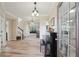 Bright foyer featuring hardwood floors, elegant lighting, and an open view into the adjacent living spaces at 251 Parc Dr, Canton, GA 30114