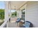 Inviting front porch features stylish chairs, a small table, and a hanging light fixture at 251 Parc Dr, Canton, GA 30114