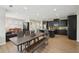 Open kitchen and dining area with dark cabinetry, stainless appliances, and hardwood floors at 251 Parc Dr, Canton, GA 30114