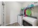 Functional laundry room equipped with a washer, dryer, and shelving for ample storage at 251 Parc Dr, Canton, GA 30114