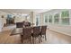 Open living space with a stone fireplace, large windows, and a dining table at 251 Parc Dr, Canton, GA 30114