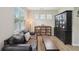 Cozy living room featuring a brown leather sofa and wooden shelving at 251 Parc Dr, Canton, GA 30114