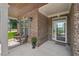 Inviting front porch with brick accents and comfortable seating, perfect for enjoying the outdoors at 251 Parc Dr, Canton, GA 30114