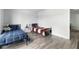 Bedroom featuring hard wood floors and two metal framed beds, with neutral paint at 2657 Lenox Ne Rd # A-5, Atlanta, GA 30324