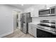Kitchen area featuring stacked washer and dryer, stainless steel refrigerator, and modern appliances at 2657 Lenox Ne Rd # A-5, Atlanta, GA 30324