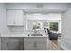 Kitchen area overlooking living room features gray cabinets and stainless steel dishwasher and sink at 2657 Lenox Ne Rd # A-5, Atlanta, GA 30324