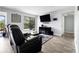 Bright living room features hardwood floors, a large window, a modern TV set up, and comfortable seating at 2657 Lenox Ne Rd # A-5, Atlanta, GA 30324