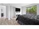Bedroom with ensuite bathroom, large window, and minimalist decor at 2657 Lenox Ne Rd # A-5, Atlanta, GA 30324