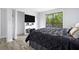 Bedroom with ensuite bathroom, large window, and minimalist decor at 2657 Lenox Ne Rd # A-5, Atlanta, GA 30324