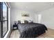 Bedroom featuring hardwood floors, king bed, window, and modern decor at 2657 Lenox Ne Rd # A-5, Atlanta, GA 30324