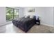 Bedroom featuring hardwood floors, king bed, window, and modern decor at 2657 Lenox Ne Rd # A-5, Atlanta, GA 30324