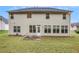 Home's back exterior featuring a patio and lush lawn, perfect for outdoor activities at 3185 Highgreen Trl, Atlanta, GA 30349