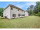 Spacious backyard with lush lawn and views of the home's rear exterior at 3185 Highgreen Trl, Atlanta, GA 30349