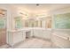 Bright bathroom boasting dual sinks, large mirrors, and a soaking tub for a spa-like experience at 3185 Highgreen Trl, Atlanta, GA 30349