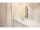 A simple bathroom with a vanity, large mirror, bright walls and view to the next room at 3185 Highgreen Trl, Atlanta, GA 30349