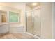 Bathroom showcasing a glass-enclosed shower, a tub and a vanity with a bright window at 3185 Highgreen Trl, Atlanta, GA 30349