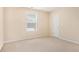 This bedroom has a simple design, a carpeted floor and a big window at 3185 Highgreen Trl, Atlanta, GA 30349