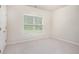 Bright bedroom featuring a window, neutral carpet and freshly painted walls at 3185 Highgreen Trl, Atlanta, GA 30349