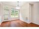 Cozy dining area featuring hardwood floors, natural light, and a door to the backyard at 3185 Highgreen Trl, Atlanta, GA 30349