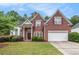 Charming brick home with a well-manicured lawn and lush landscaping at 3185 Highgreen Trl, Atlanta, GA 30349