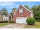 Lovely brick home with attached two car garage, neat lawn and bushes at 3185 Highgreen Trl, Atlanta, GA 30349
