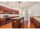 Spacious kitchen showcasing an island, modern appliances, pendant lighting, and rich dark wood cabinets at 3185 Highgreen Trl, Atlanta, GA 30349