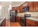 Well-equipped kitchen featuring stainless steel appliances, ample counter space, and dark wood cabinets at 3185 Highgreen Trl, Atlanta, GA 30349