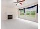 Bright living room featuring plush carpeting, a fireplace, and large windows at 3185 Highgreen Trl, Atlanta, GA 30349