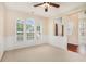 Bright living room with large arched windows, wainscoting details, and neutral carpet at 3185 Highgreen Trl, Atlanta, GA 30349