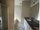 Modern bathroom featuring dual vanity sinks, granite countertops, a bathtub, and a shower at 4287 Traipse Path, Ellenwood, GA 30294