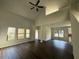 Spacious living room featuring tall ceilings, dark hardwood floors, and plenty of natural light at 4287 Traipse Path, Ellenwood, GA 30294