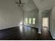 Open-concept living room with high ceilings, three large windows, and hardwood flooring at 4287 Traipse Path, Ellenwood, GA 30294