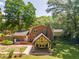 Aerial view of brick home with new outdoor living area, hot tub and landscaped yard at 1652 Weymouth Ct, Tucker, GA 30084