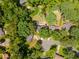 An aerial shot reveals a home nestled in lush greenery, showcasing its private backyard and landscaping at 1652 Weymouth Ct, Tucker, GA 30084