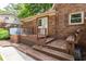 Backyard with a brick house, wooden deck, and hot tub at 1652 Weymouth Ct, Tucker, GA 30084