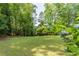 Lovely grassy backyard with hydrangeas and mature trees at 1652 Weymouth Ct, Tucker, GA 30084