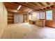 Unfinished basement space featuring built-in shelving and work bench, perfect for storage or workshop at 1652 Weymouth Ct, Tucker, GA 30084