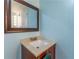 Bathroom vanity featuring a light countertop, wood cabinets, and decorative mirror at 1652 Weymouth Ct, Tucker, GA 30084