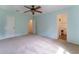 Spacious bedroom featuring a ceiling fan, closet, and attached bathroom at 1652 Weymouth Ct, Tucker, GA 30084