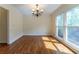 Dining room with hardwood floors, a chandelier, and natural light from a large window at 1652 Weymouth Ct, Tucker, GA 30084