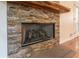 Close up of a stone fireplace featuring a wooden mantel in the living room at 1652 Weymouth Ct, Tucker, GA 30084